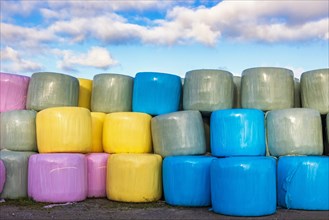 Colorful plastic bales on a farm