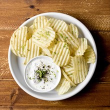 Top view potato chips plate with sauce