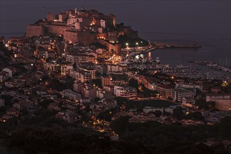 The illuminated town of Calvi at night on the northwest coast of Corsica France Europe