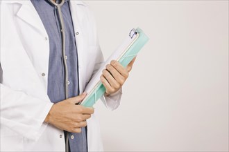 Doctor s hands with clipboard folder