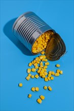 Overturned tin can filled with corn