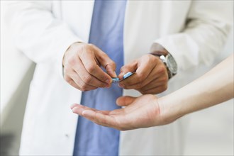 Doctor giving pills
