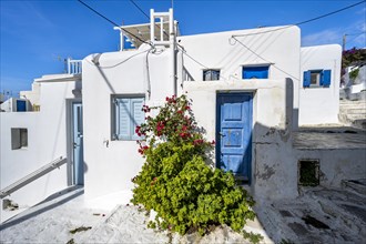 Cycladic white houses with blue shutters and doors