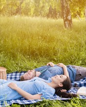 Young attractive couple relaxing picnic nature