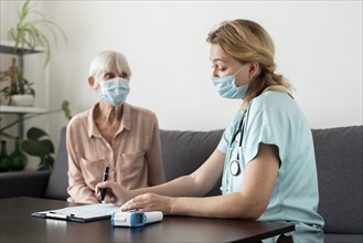 Nurse senior woman during check up nursing home