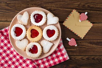 Top view heart shaped cookies plate with jam