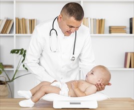 Careful doctor holding baby patient head