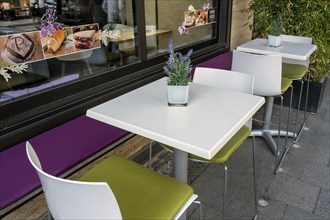 White tables and chairs in front of bistro