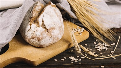 Loaf bread ear wheat dark wooden background