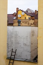 Stepladder leaning against a backyard facadein the historic old town of Ceske Budejovice