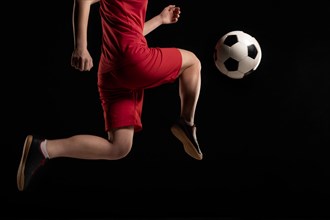 Close up woman kicking ball with knee