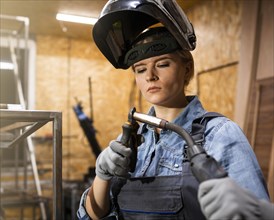 Front view woman with welding tool
