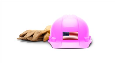 Pink hardhat with an american flag decal on the front and gloves isolated on white background