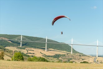 Paraglider in front of the Millau Bridge. Grands Causses