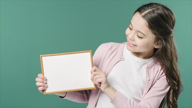 Girl holding empty picture frame