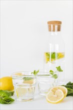 Glasses bottle with lemon mint drink