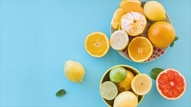 Overhead view juicy citrus fruits blue backdrop