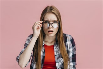 Woman with glasses looking suspicious