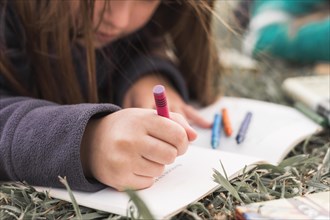 Anonymous girl drawing grass