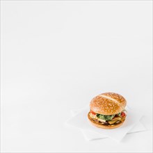 Close up fresh burger tissue paper white backdrop