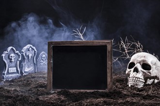 Night graveyard with skull black sign