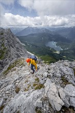 Climber on Waxenstein on rocky exposed path