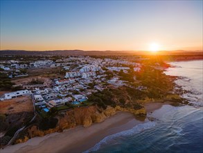 The sun rises in the Algarve Portugal in the district of Faro near the town of Albufeira.