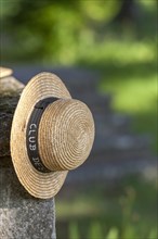 Straw hat hanging on a wall