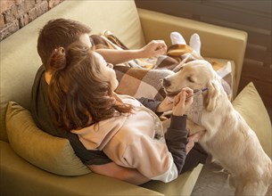 Full shot couple couch with dog