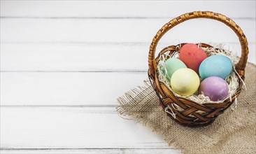 Easter eggs basket wooden table