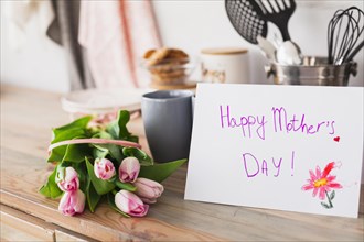 Happy mothers day inscription with tulips table