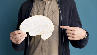 Close up man pointing paper brain