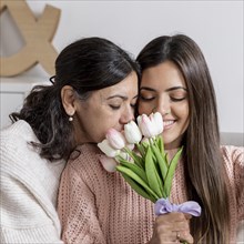Happy mom daughter with flowers