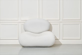 Large soft pouf or beanbag chair in bright room