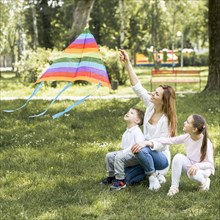 Mother children playing with kite