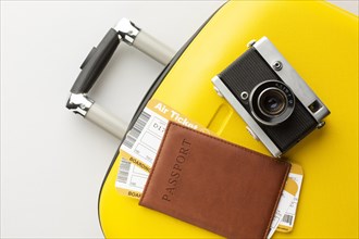 Yellow luggage with camera passport