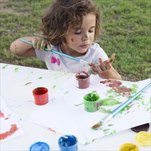 Cute little girl drawing painting canvas park