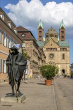 Bronze sculpture Jacob's Pilgrim by Martin Mayer and behind it The Imperial Cathedral of Speyer also called Speyer Cathedral or Cathedral Church of St Mary and St Stephen