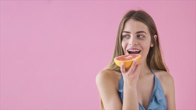 Girl bikini eating grapefruit