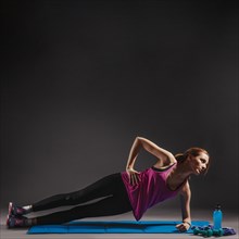 Young woman doing side plank