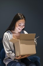 Woman looking box after ordering online