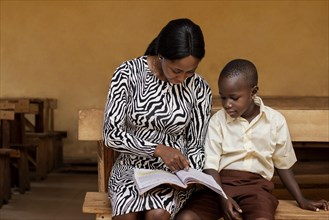 African woman teaching kids class