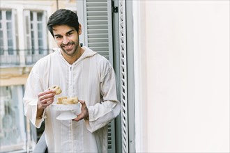 Eid al fitr concept with muslim man eating