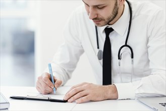 Close up doctor writing