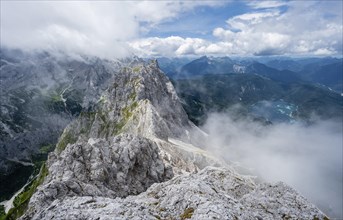 View from the summit of the Waxenstein over the rocky and narrow ridge of the Waxenstein ridge to the Eibsee lake and Hoellental