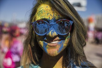 Blue yellow holi color powder woman s face