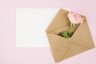 White blank card brown envelope with rose pink background