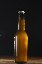 Close up beer bottle wooden desk