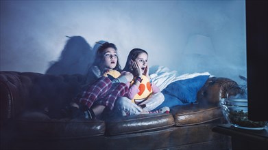Girls watching scary movie alone