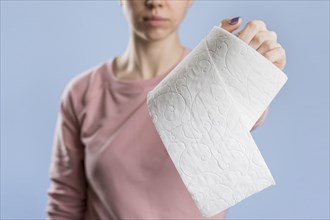 Front view woman holding toilet paper roll
